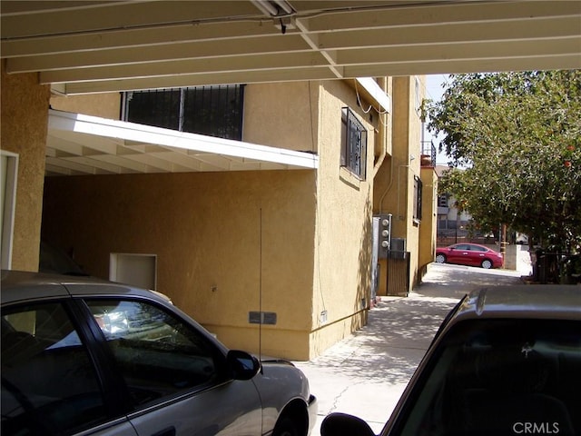 view of side of home with a carport