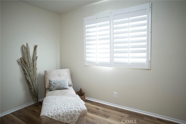 sitting room with hardwood / wood-style flooring