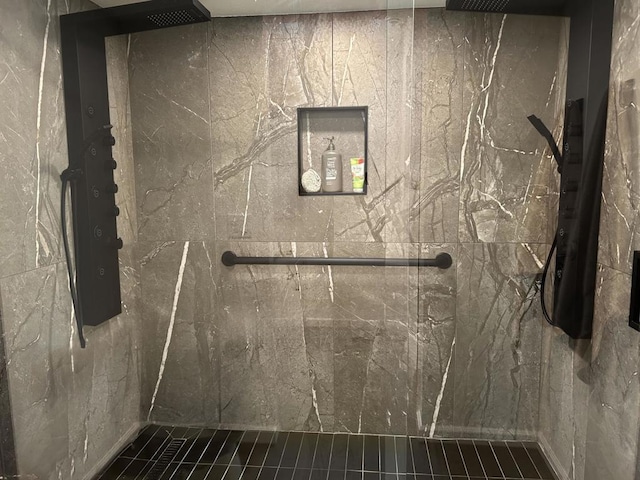 bathroom with a tile shower