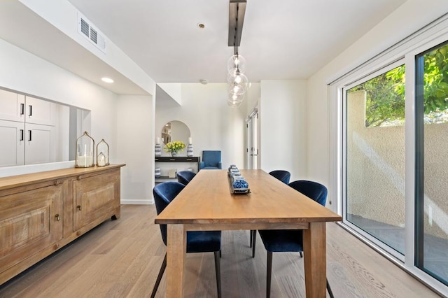 dining space with light hardwood / wood-style flooring