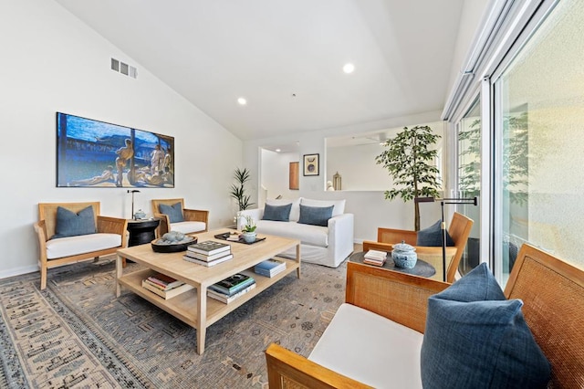 living room with high vaulted ceiling