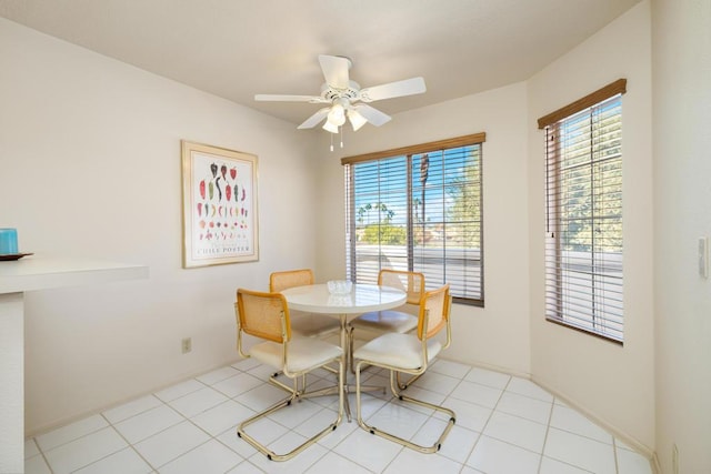 tiled dining space with ceiling fan