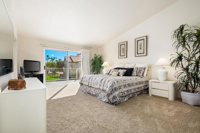 carpeted bedroom with access to exterior and vaulted ceiling