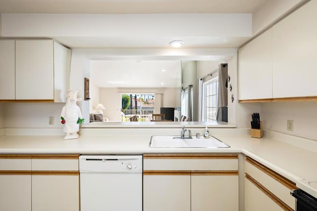 kitchen featuring white cabinetry, sink, white dishwasher, and stove