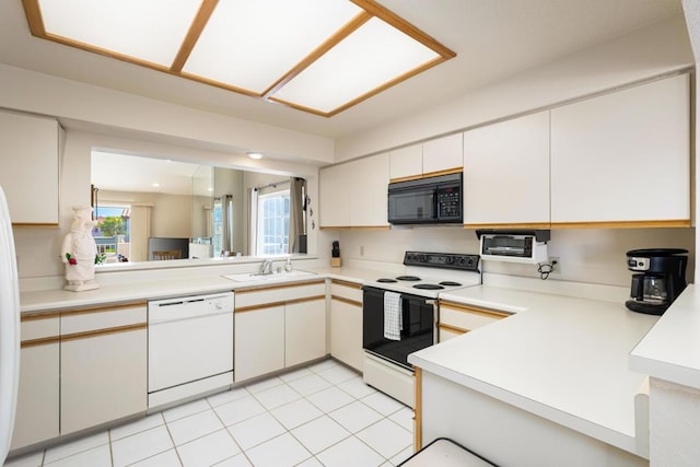 kitchen featuring white cabinets, white appliances, light tile patterned flooring, and sink