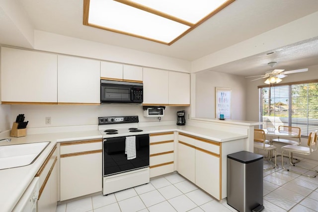 kitchen with white appliances, white cabinets, sink, ceiling fan, and kitchen peninsula