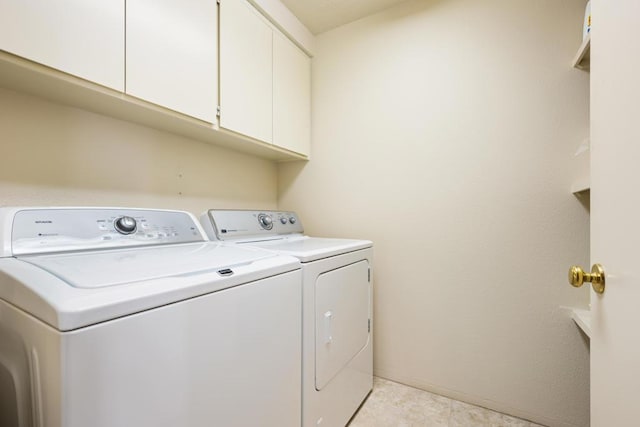 laundry area featuring cabinets and washing machine and clothes dryer