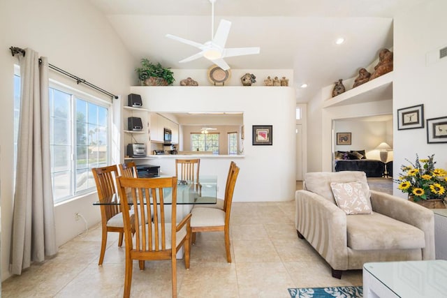 tiled dining room featuring vaulted ceiling and ceiling fan