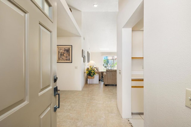 corridor with light tile patterned floors