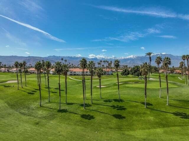 view of community featuring a lawn and a mountain view