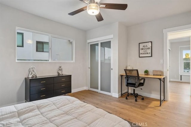 bedroom featuring ceiling fan, a closet, and light hardwood / wood-style flooring