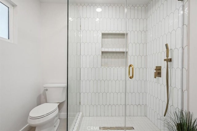 bathroom with toilet and an enclosed shower