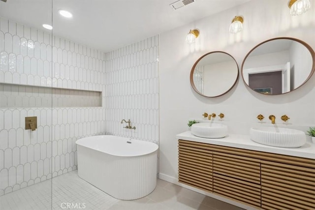 bathroom featuring tile walls, tile patterned floors, separate shower and tub, and vanity