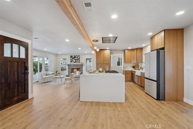 kitchen featuring light hardwood / wood-style flooring, appliances with stainless steel finishes, and a center island