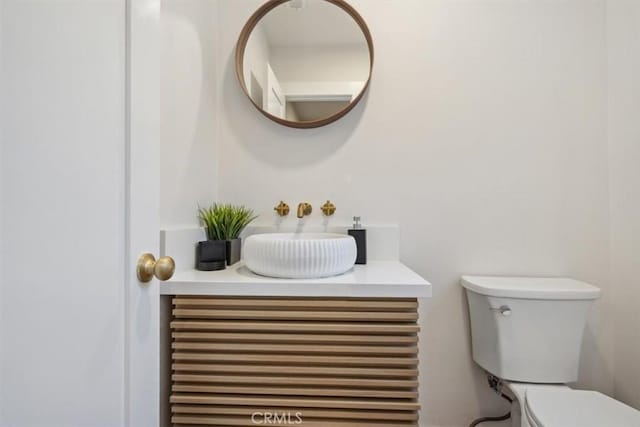 bathroom with toilet and vanity