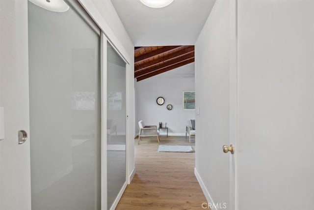 corridor featuring wooden ceiling, wood-type flooring, and vaulted ceiling with beams