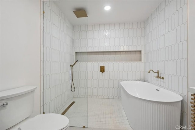 bathroom with tile patterned floors, toilet, and shower with separate bathtub