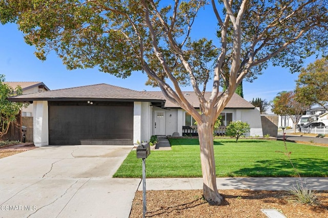 view of front of house featuring a front lawn and a garage