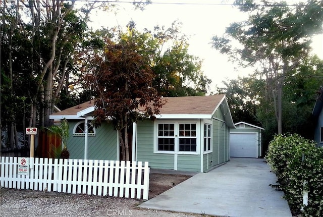 view of front of home featuring a garage and an outdoor structure