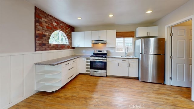 kitchen with a wealth of natural light, open shelves, stainless steel appliances, and under cabinet range hood