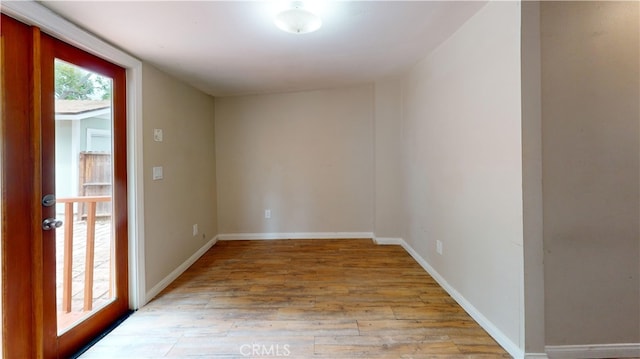 unfurnished room featuring light wood-style flooring and baseboards
