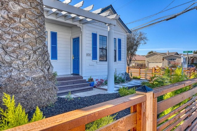 entrance to property featuring a pergola