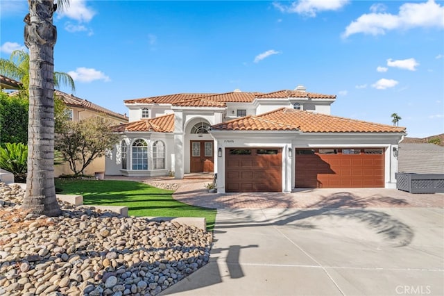 mediterranean / spanish home featuring a front yard