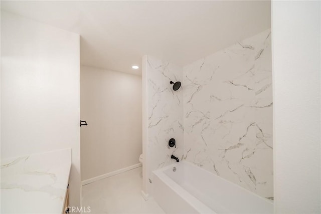 full bathroom with tiled shower / bath combo, toilet, and vanity