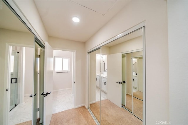 hallway featuring light colored carpet