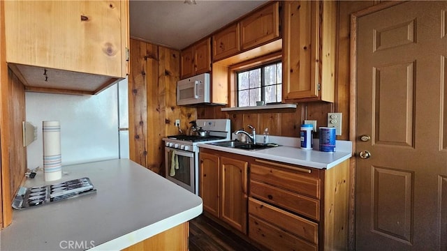 kitchen featuring white appliances and sink