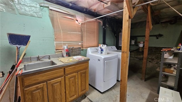 laundry area with cabinets, washer and clothes dryer, and sink