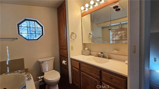 bathroom with a bath, vanity, and toilet