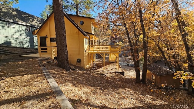 view of side of home featuring a wooden deck