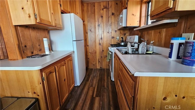 kitchen with white appliances and dark wood-type flooring