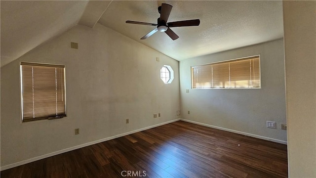 spare room featuring a textured ceiling, ceiling fan, lofted ceiling with beams, and dark hardwood / wood-style floors