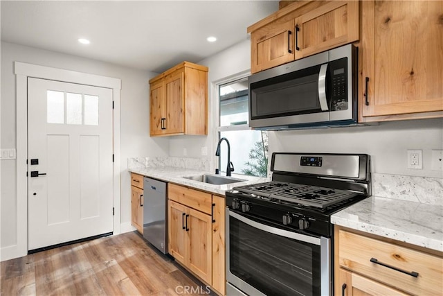 kitchen featuring sink, plenty of natural light, light hardwood / wood-style floors, and appliances with stainless steel finishes