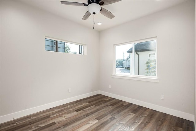 unfurnished room featuring ceiling fan and dark hardwood / wood-style flooring