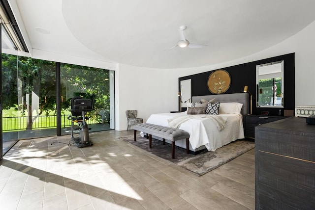 bedroom featuring ceiling fan, light hardwood / wood-style floors, and access to outside