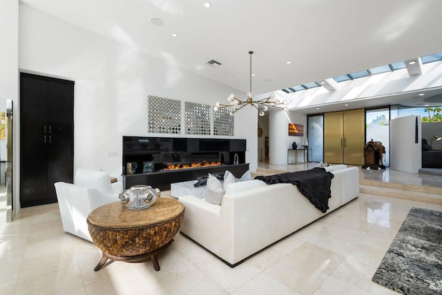 living room with light tile patterned flooring, a towering ceiling, and an inviting chandelier