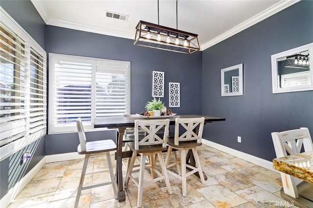 dining space featuring crown molding