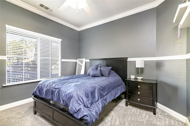 carpeted bedroom with ceiling fan and crown molding