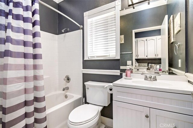 full bathroom featuring shower / tub combo, vanity, and toilet