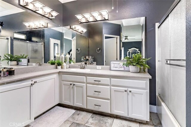 bathroom with vanity, ceiling fan, and enclosed tub / shower combo