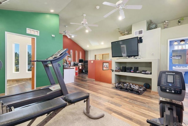 exercise area featuring hardwood / wood-style floors, ceiling fan, and lofted ceiling