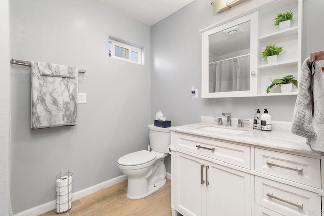 bathroom featuring a shower with curtain, vanity, wood-type flooring, and toilet