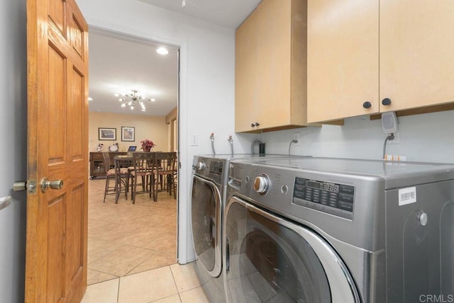 laundry room featuring cabinets, separate washer and dryer, and light tile patterned floors