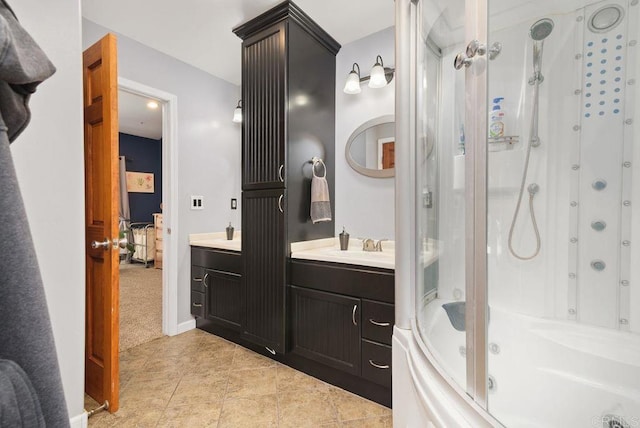 bathroom featuring tile patterned flooring, vanity, and a shower with shower door