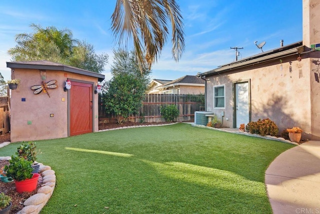 view of yard with central AC and a shed