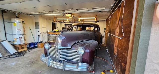 garage with electric panel and water heater