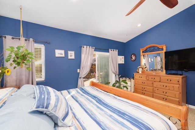 carpeted bedroom with vaulted ceiling and ceiling fan